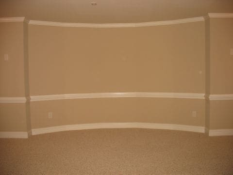 A room with two walls painted beige and white.