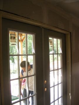 A child is looking out of the window.